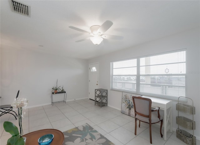 tiled office space featuring ceiling fan