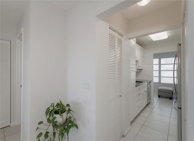 hall with light tile patterned floors