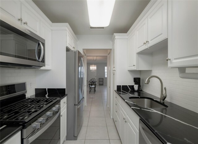 2960 59th St S Unit 509, Gulfport, FL 33707 - kitchen featuring stainless steel appliances, a sink, dark countertops, and decorative backsplash