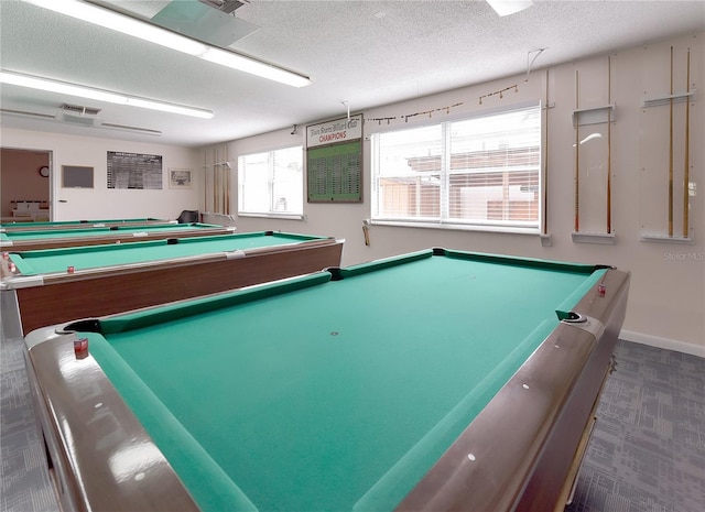 playroom with dark colored carpet, a textured ceiling, and pool table