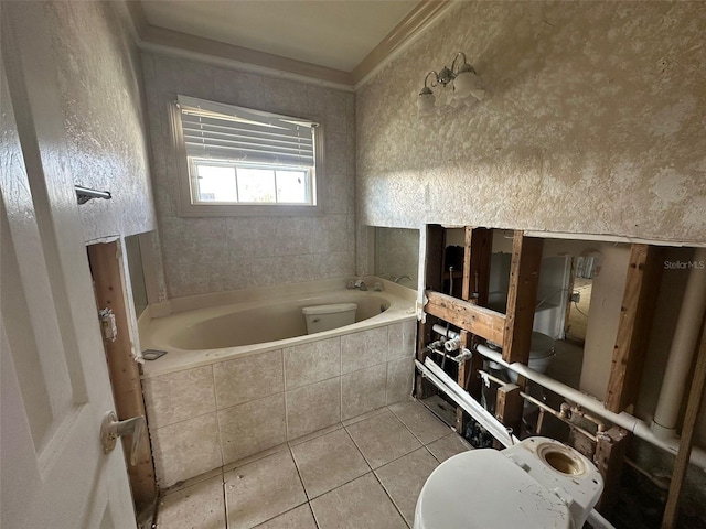 bathroom with toilet, tiled bath, tile patterned floors, and crown molding