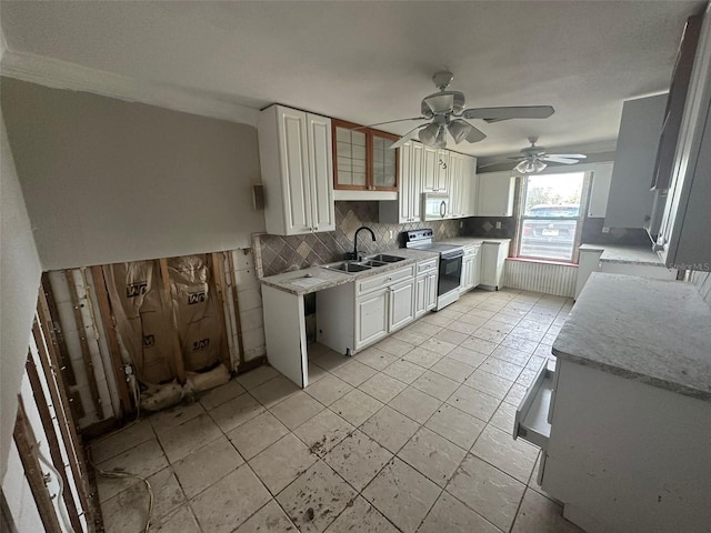 kitchen featuring sink, tasteful backsplash, white electric range oven, white cabinetry, and ceiling fan