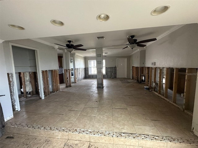 spare room featuring ornamental molding and ceiling fan