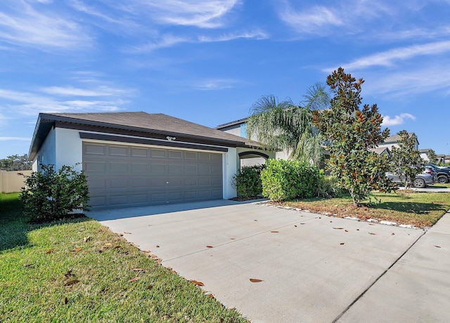 view of front of house featuring a front yard and a garage