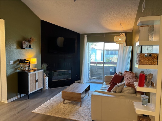 living room with hardwood / wood-style flooring and a textured ceiling