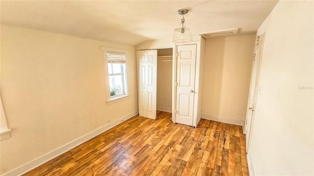 unfurnished bedroom with hardwood / wood-style flooring