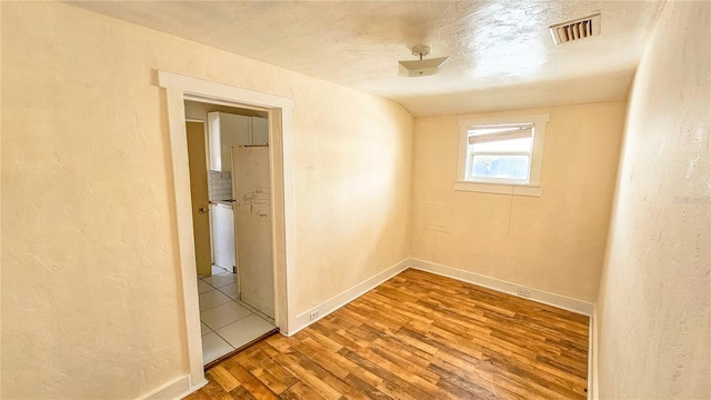 empty room with wood-type flooring