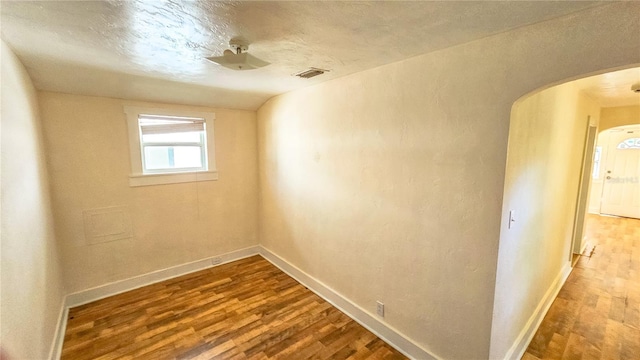 unfurnished room with wood-type flooring