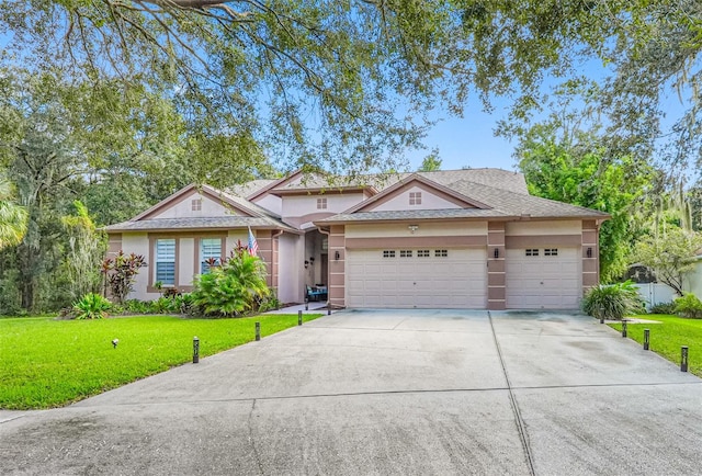 view of front of property with a front lawn and a garage