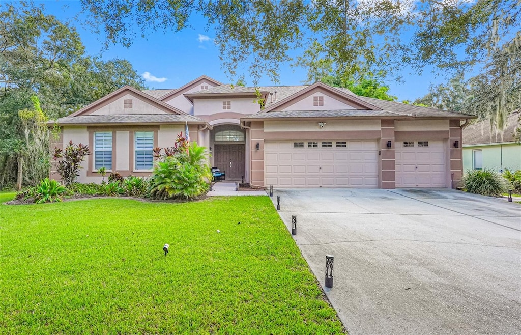 view of front of house with a garage and a front yard