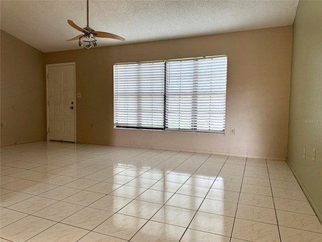 unfurnished room featuring ceiling fan, a textured ceiling, and light tile patterned floors