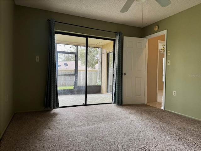 carpeted empty room with a textured ceiling and ceiling fan