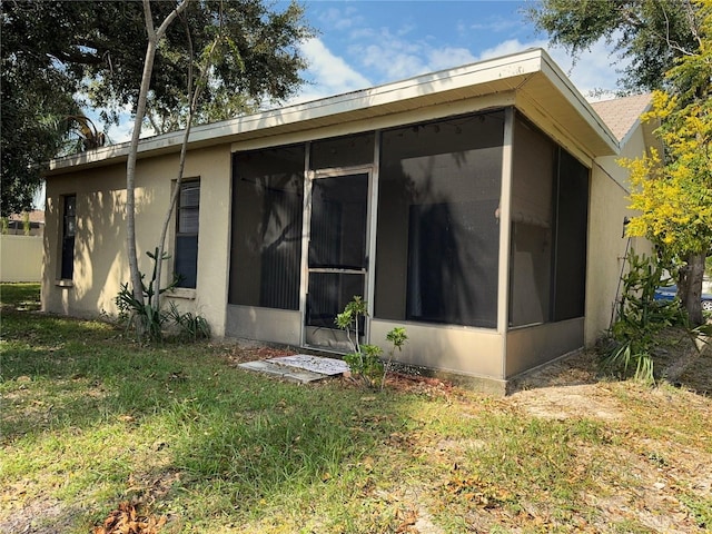 view of property exterior featuring a sunroom