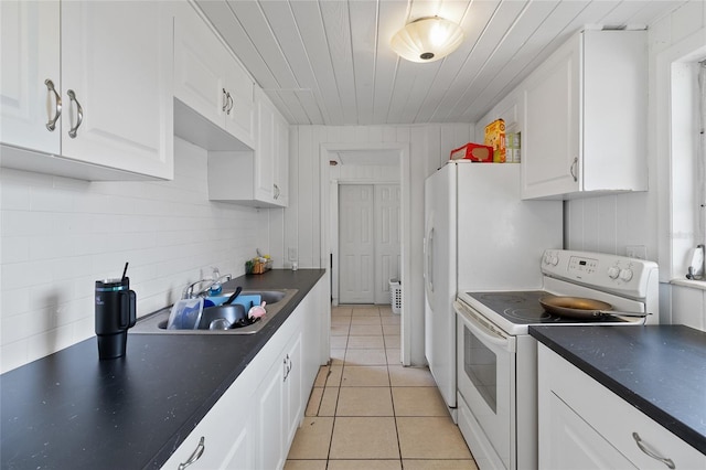 205 Santurce Ave, North Port, FL 34287 - kitchen featuring a sink, dark countertops, electric range, white cabinets, and light tile patterned flooring