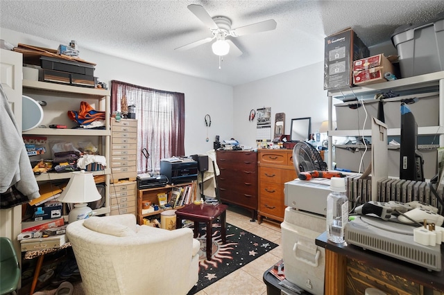 tiled home office featuring ceiling fan and a textured ceiling