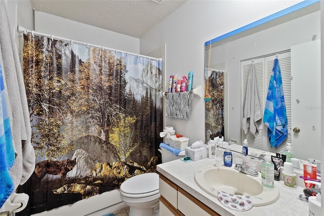 bathroom with vanity, a shower with curtain, toilet, and a textured ceiling