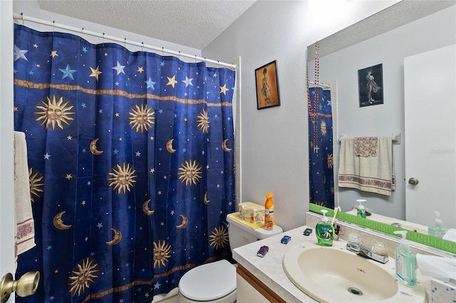 bathroom featuring vanity, curtained shower, toilet, and a textured ceiling