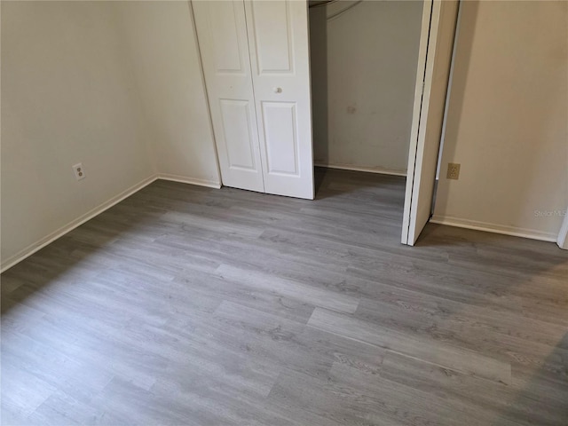 304 Camillia Ln Unit B, Port Charlotte, FL 33954 - unfurnished bedroom with wood finished floors, baseboards, and a closet