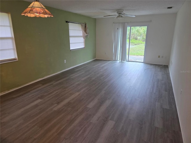 304 Camillia Ln Unit B, Port Charlotte, FL 33954 - spare room with a ceiling fan, dark wood-style floors, and baseboards