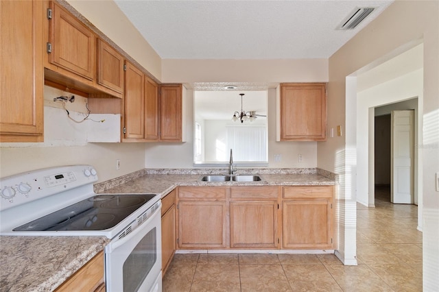 kitchen with white electric range, sink, light tile patterned floors, a notable chandelier, and pendant lighting