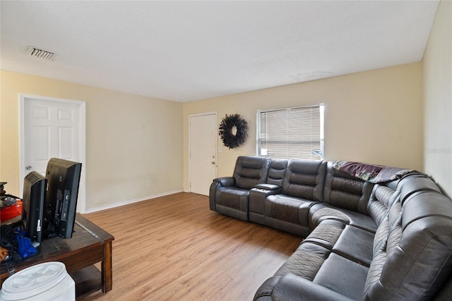 living room with hardwood / wood-style flooring and a textured ceiling