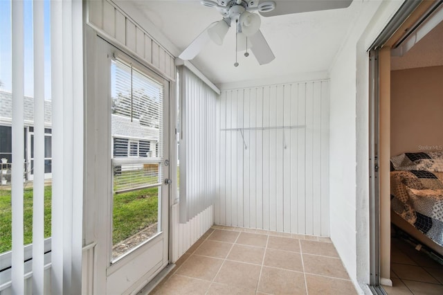 sunroom featuring ceiling fan and a wealth of natural light