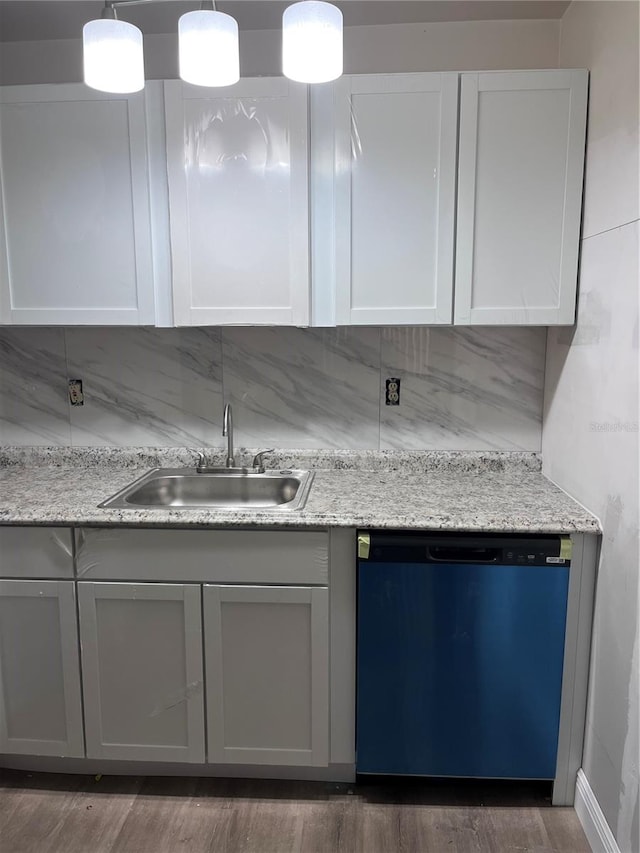 kitchen with decorative backsplash, stainless steel dishwasher, dark wood-type flooring, sink, and decorative light fixtures