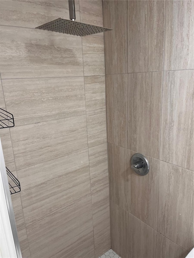 bathroom with tiled shower