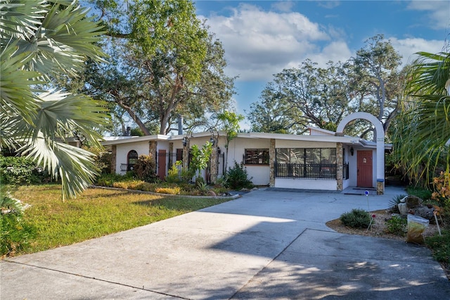 ranch-style home with a front lawn