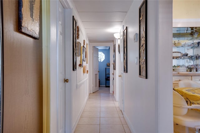 hall with light tile patterned floors