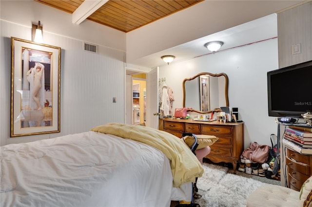 bedroom featuring beamed ceiling and wooden ceiling