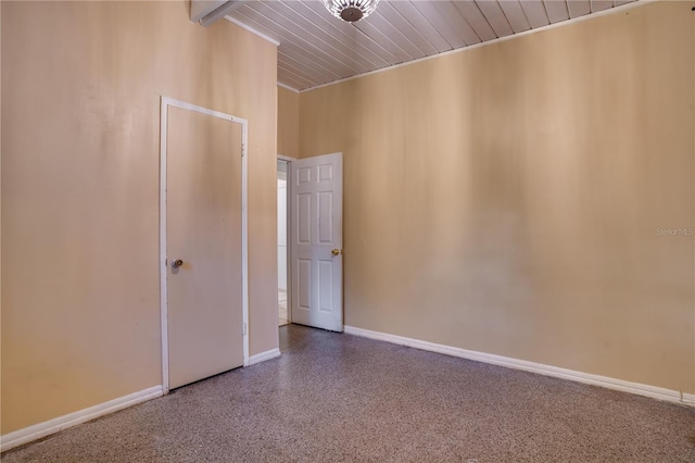 spare room with beamed ceiling and wood ceiling