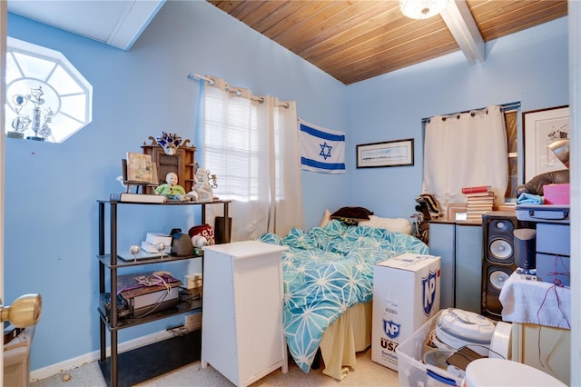 carpeted bedroom featuring beam ceiling and wood ceiling