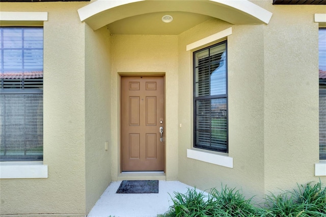 entrance to property with stucco siding
