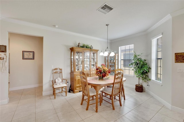 tiled dining room featuring an inviting chandelier and ornamental molding