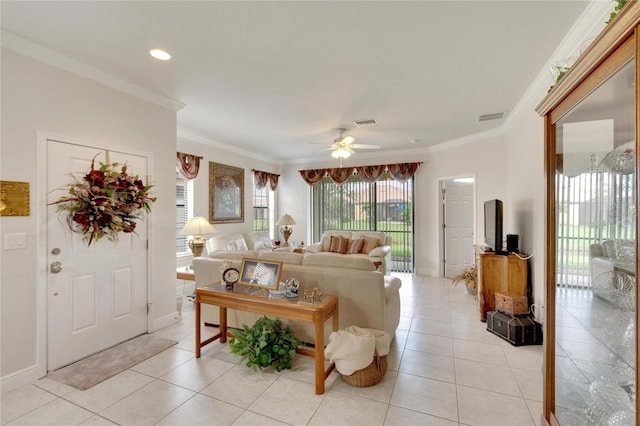 living area featuring light tile patterned flooring, crown molding, ceiling fan, and visible vents