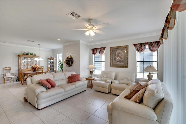 tiled living room featuring ceiling fan and ornamental molding