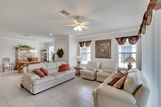 living room with crown molding, ceiling fan, and visible vents