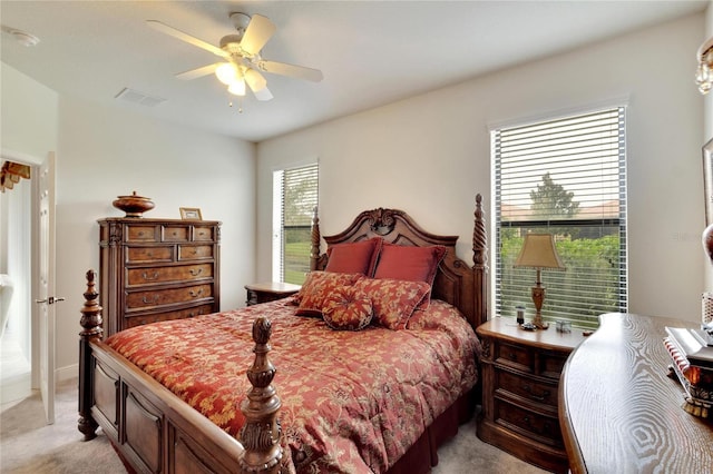 bedroom featuring light carpet, ceiling fan, and visible vents