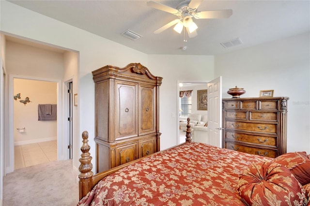 carpeted bedroom with tile patterned floors, baseboards, a ceiling fan, and visible vents