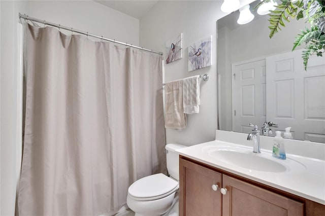 bathroom with toilet, curtained shower, and vanity