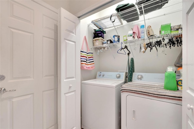 clothes washing area featuring separate washer and dryer