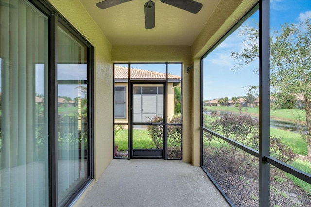 unfurnished sunroom featuring a ceiling fan