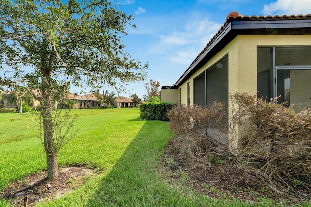 view of yard featuring a sunroom