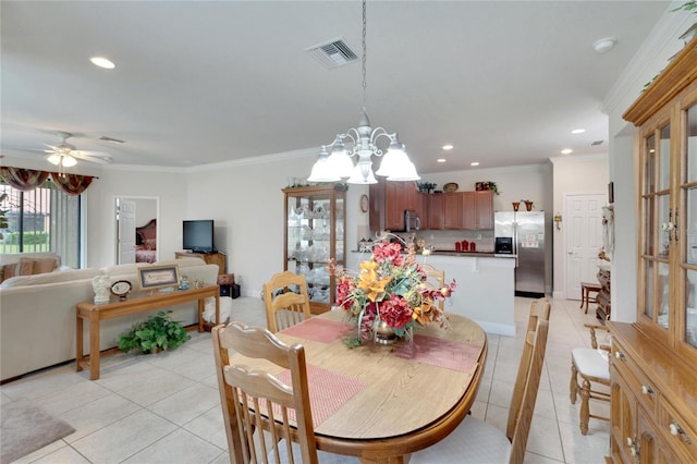 dining room with ceiling fan with notable chandelier, ornamental molding, and light tile patterned flooring