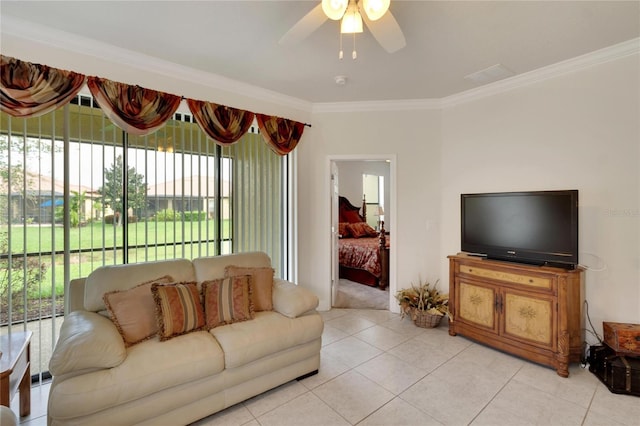 tiled living room with ceiling fan and crown molding