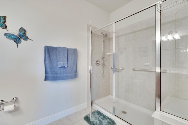 bathroom with tile patterned flooring and a shower with door