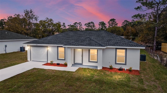 15499 SW 27th Ln, Ocala, FL 34481 - back of house with roof with shingles, driveway, stucco siding, and an attached garage