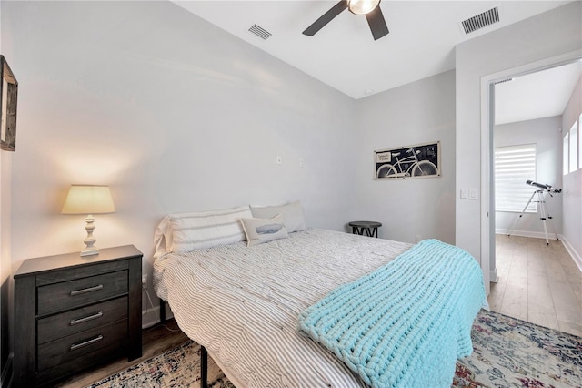 bedroom with light hardwood / wood-style flooring and ceiling fan