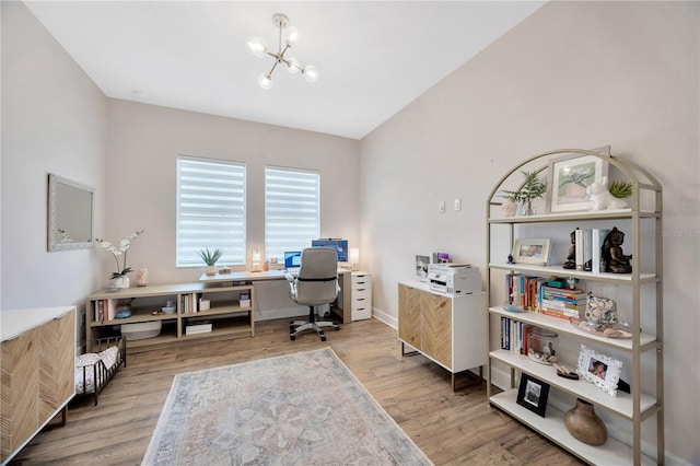 office with a chandelier and light hardwood / wood-style flooring